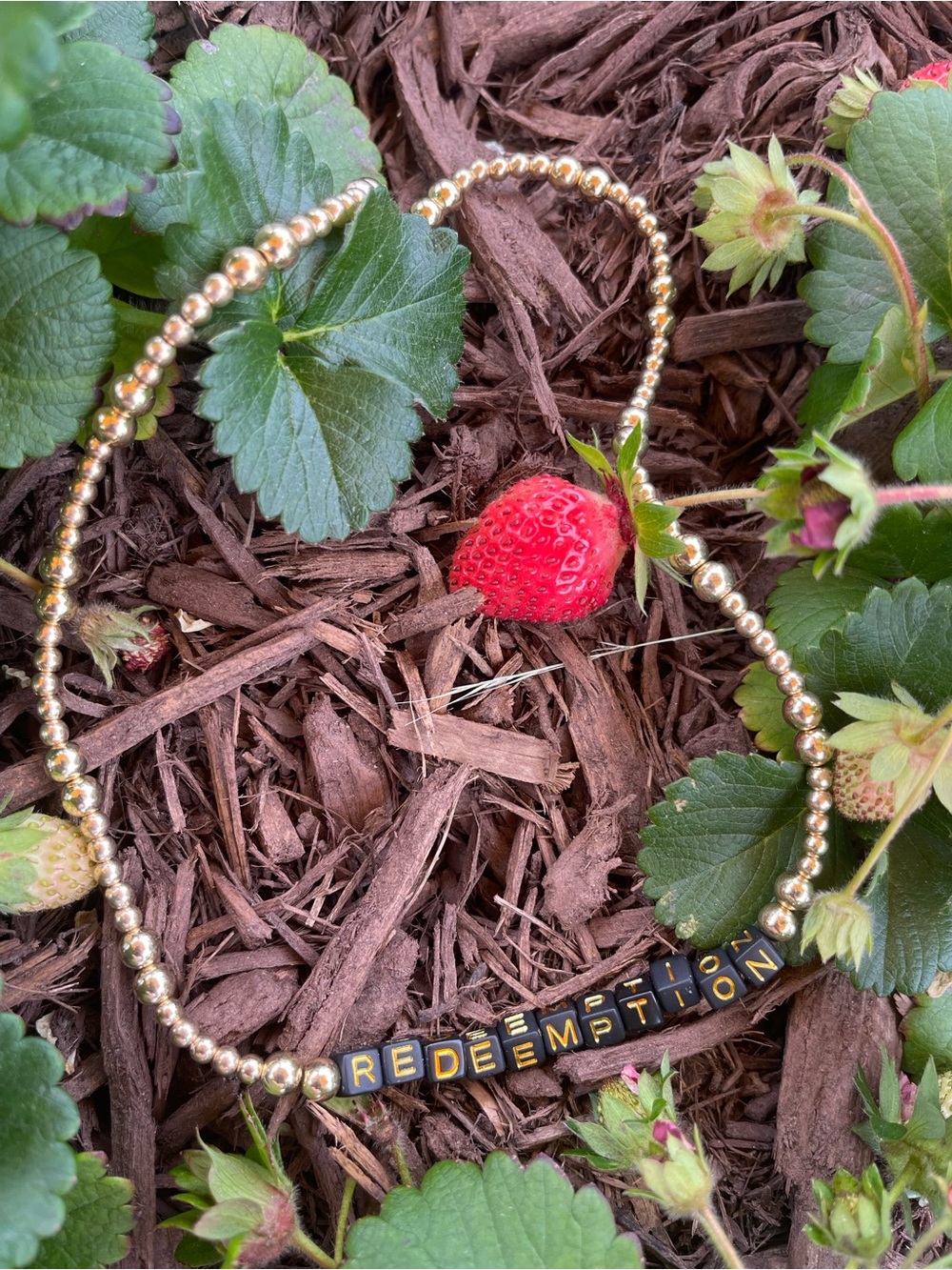 Gold Beaded Necklace with Black Letter Beads Spelling REDEMPTION